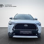Weiße Toyota Corolla Cross Hybrid Frontansicht.